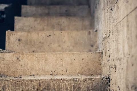 A set of concrete basement steps with water damage illustrates the points featured in this article.